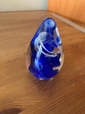 Art glass paperweight egg-shaped design with abstract blue swirls w/clear glass
